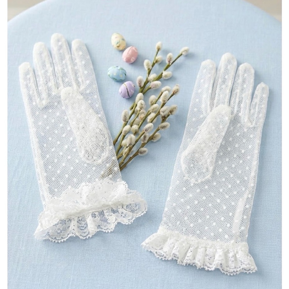 white polka dot (Swiss dot) pattern on mesh with ruffled lace cuffs.